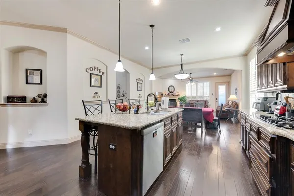 a kitchen with lots of counter top space and painting on the wall