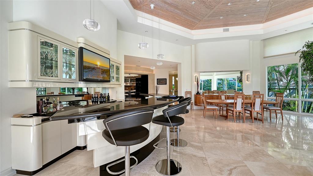 510 Harbor Gate Way Longboat Key, FL 34228 - Photo 14 of 98 a kitchen with sink cabinets and dining table