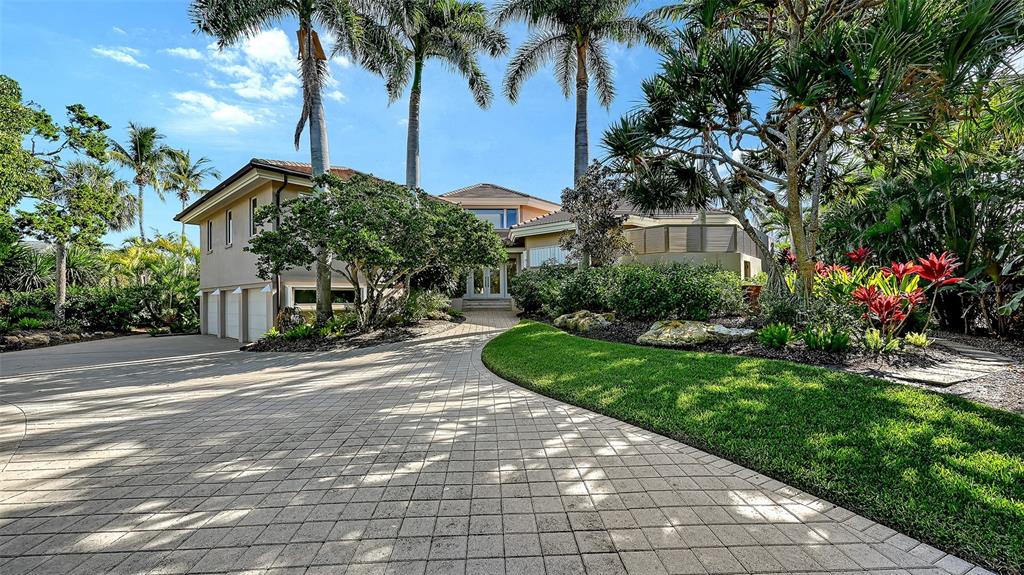 510 Harbor Gate Way Longboat Key, FL 34228 - Photo 2 of 98 a view of a garden with a building in the background