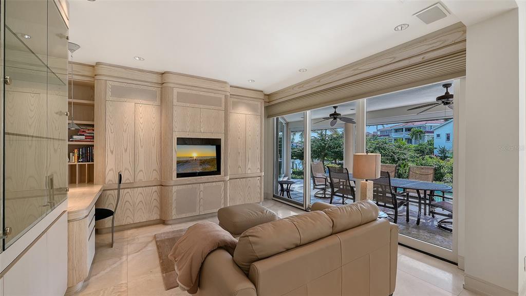 510 Harbor Gate Way Longboat Key, FL 34228 - Photo 24 of 98 a living room with furniture a flat screen tv and a large window