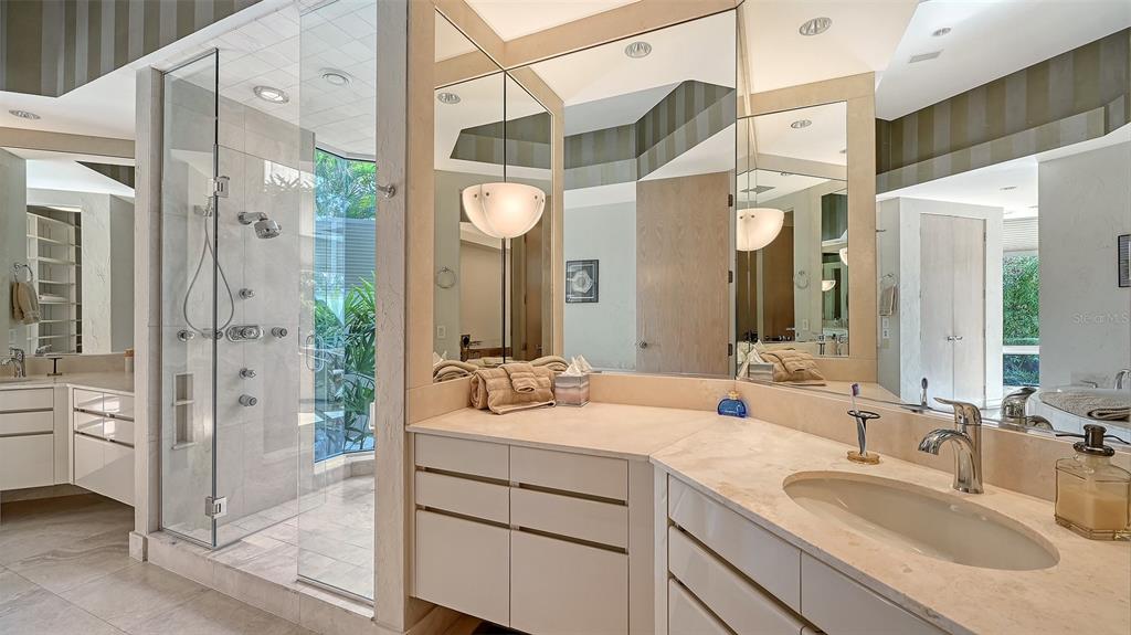 510 Harbor Gate Way Longboat Key, FL 34228 - Photo 30 of 98 a bathroom with a sink vanity granite shower and a mirror