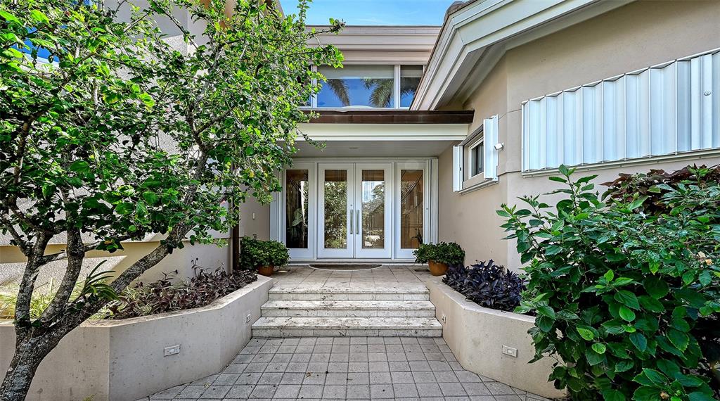 510 Harbor Gate Way Longboat Key, FL 34228 - Photo 3 of 98 a view of a house with potted plants and a potted plant