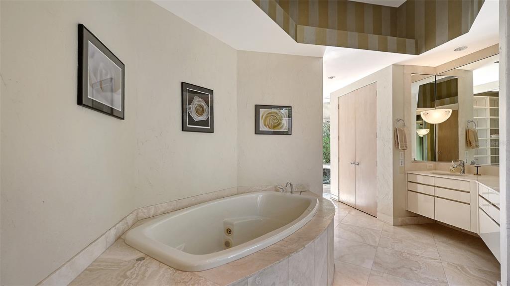 510 Harbor Gate Way Longboat Key, FL 34228 - Photo 31 of 98 a bathroom with a tub and shower