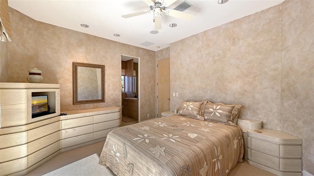 510 Harbor Gate Way Longboat Key, FL 34228 - Photo 43 of 98 a bedroom with a bed and a fireplace