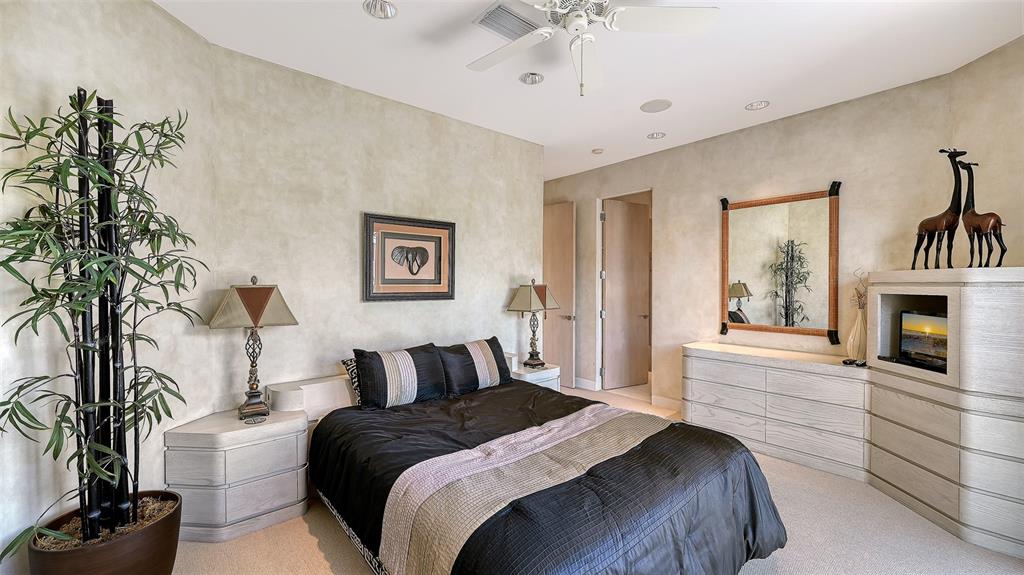 510 Harbor Gate Way Longboat Key, FL 34228 - Photo 47 of 98 a bedroom with a bed and a fireplace