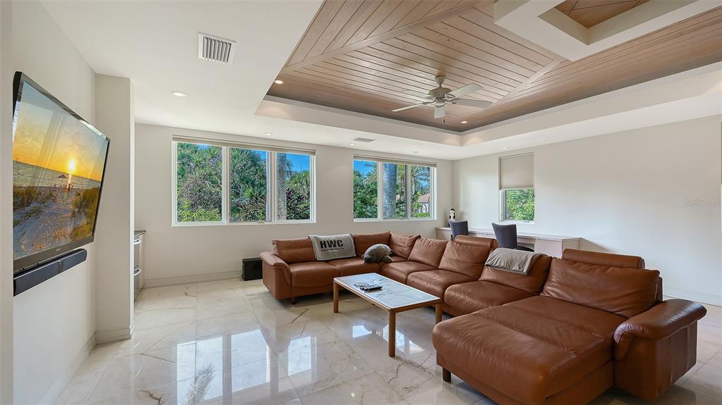 510 Harbor Gate Way Longboat Key, FL 34228 - Photo 51 of 98 a living room with furniture and a flat screen tv