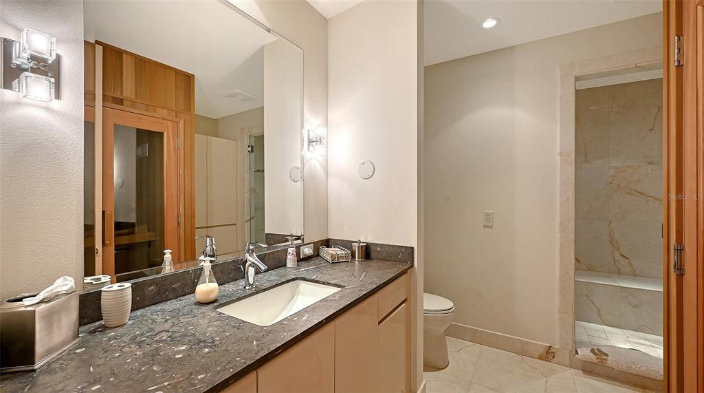 510 Harbor Gate Way Longboat Key, FL 34228 - Photo 54 of 98 a bathroom with a granite countertop sink and a mirror