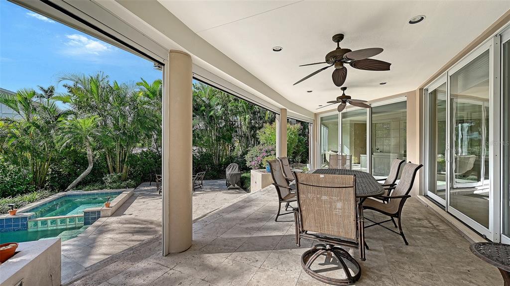 510 Harbor Gate Way Longboat Key, FL 34228 - Photo 63 of 98 a patio with yard glass top table and chairs