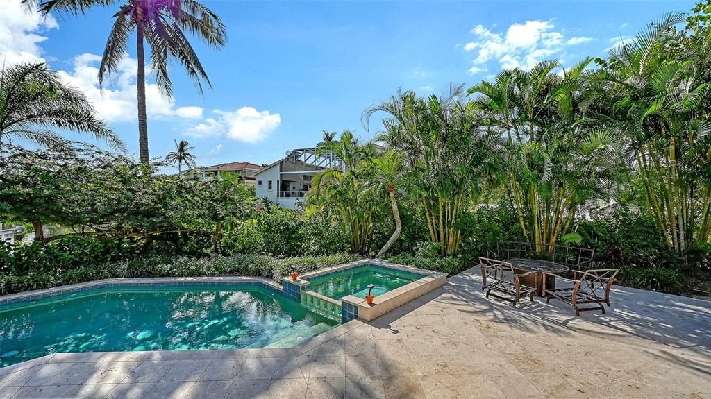 510 Harbor Gate Way Longboat Key, FL 34228 - Photo 65 of 98 a view of backyard with a table and chairs and potted plants