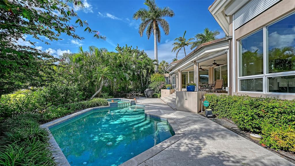 510 Harbor Gate Way Longboat Key, FL 34228 - Photo 71 of 98 a view of a house with a small yard and floor to ceiling window