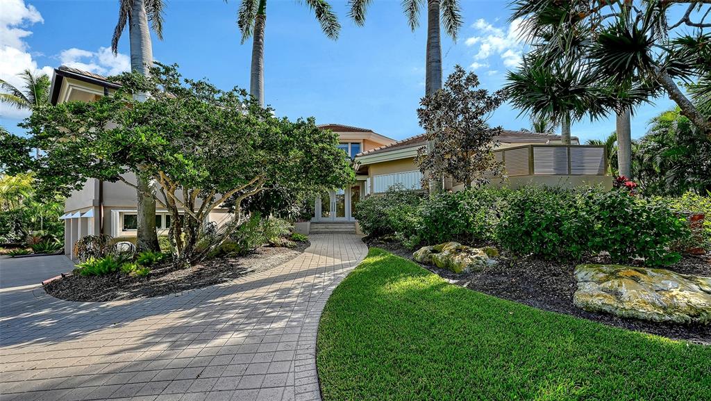 510 Harbor Gate Way Longboat Key, FL 34228 - Photo 84 of 98 a front view of a house with a yard and potted plants