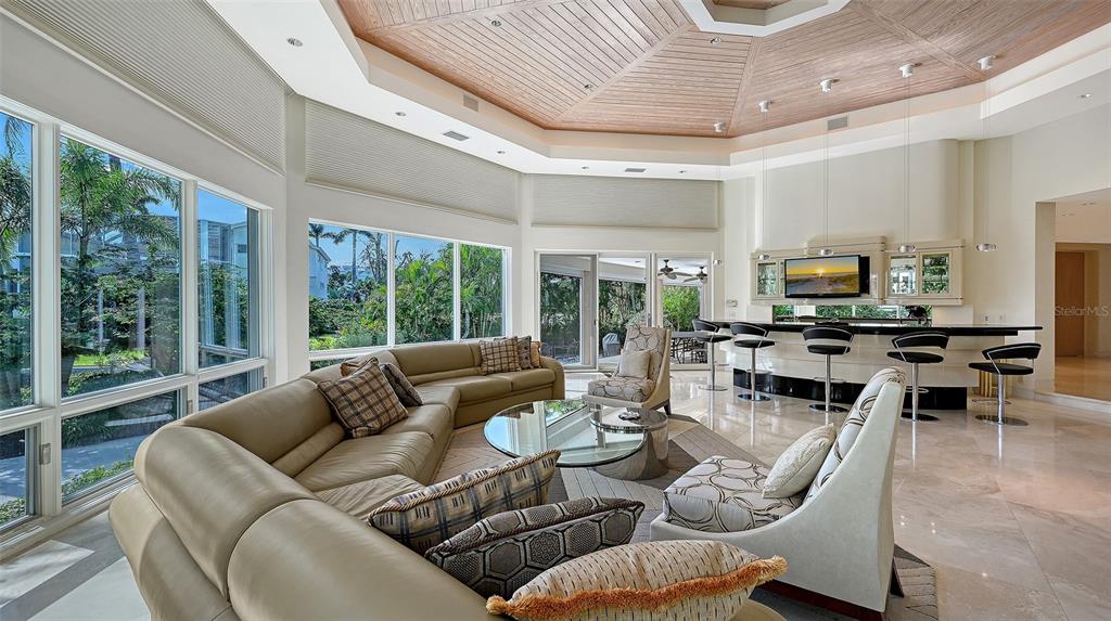 510 Harbor Gate Way Longboat Key, FL 34228 - Photo 10 of 98 a living room with furniture flat screen tv and a large window