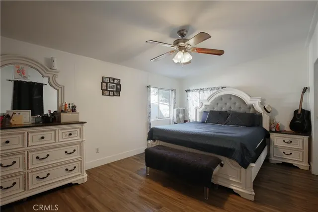 a bedroom with a bed and a dresser in it