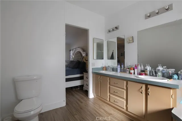 a view of bathroom with a toilet a sink and mirror