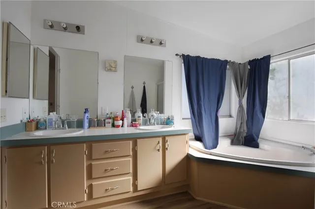 a bathroom with a double vanity sink and a mirror