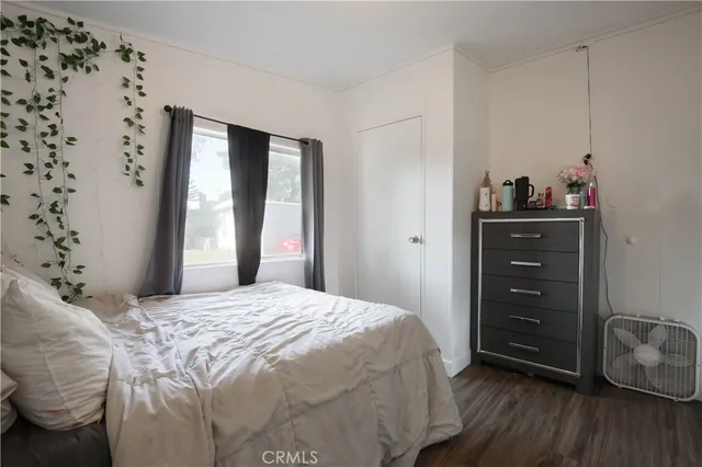 a bedroom with a bed and a dresser