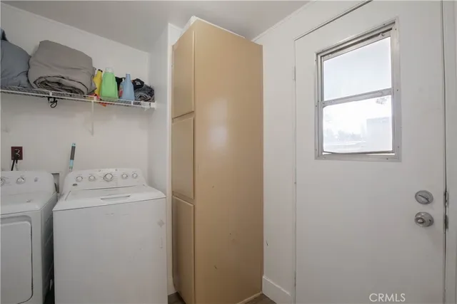 a view of storage and utility room with washer and dryer