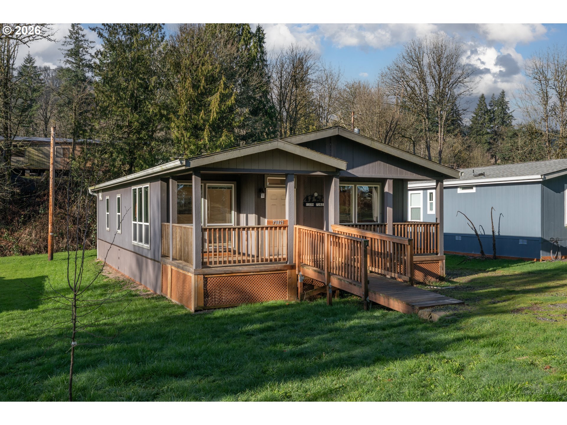 73821 Lindberg Road Rainier, OR 97048 - Photo 2 of 18 a view of a house with a yard and a deck