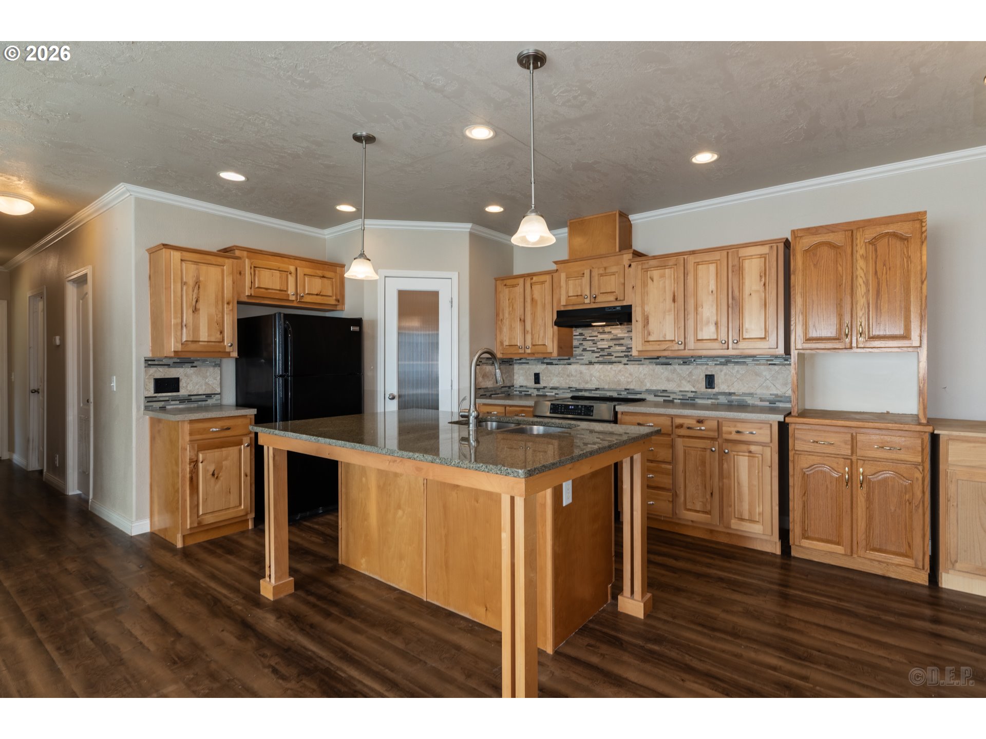 73821 Lindberg Road Rainier, OR 97048 - Photo 9 of 18 a kitchen with stainless steel appliances granite countertop a refrigerator a sink dishwasher a stove and white cabinets with wooden floor