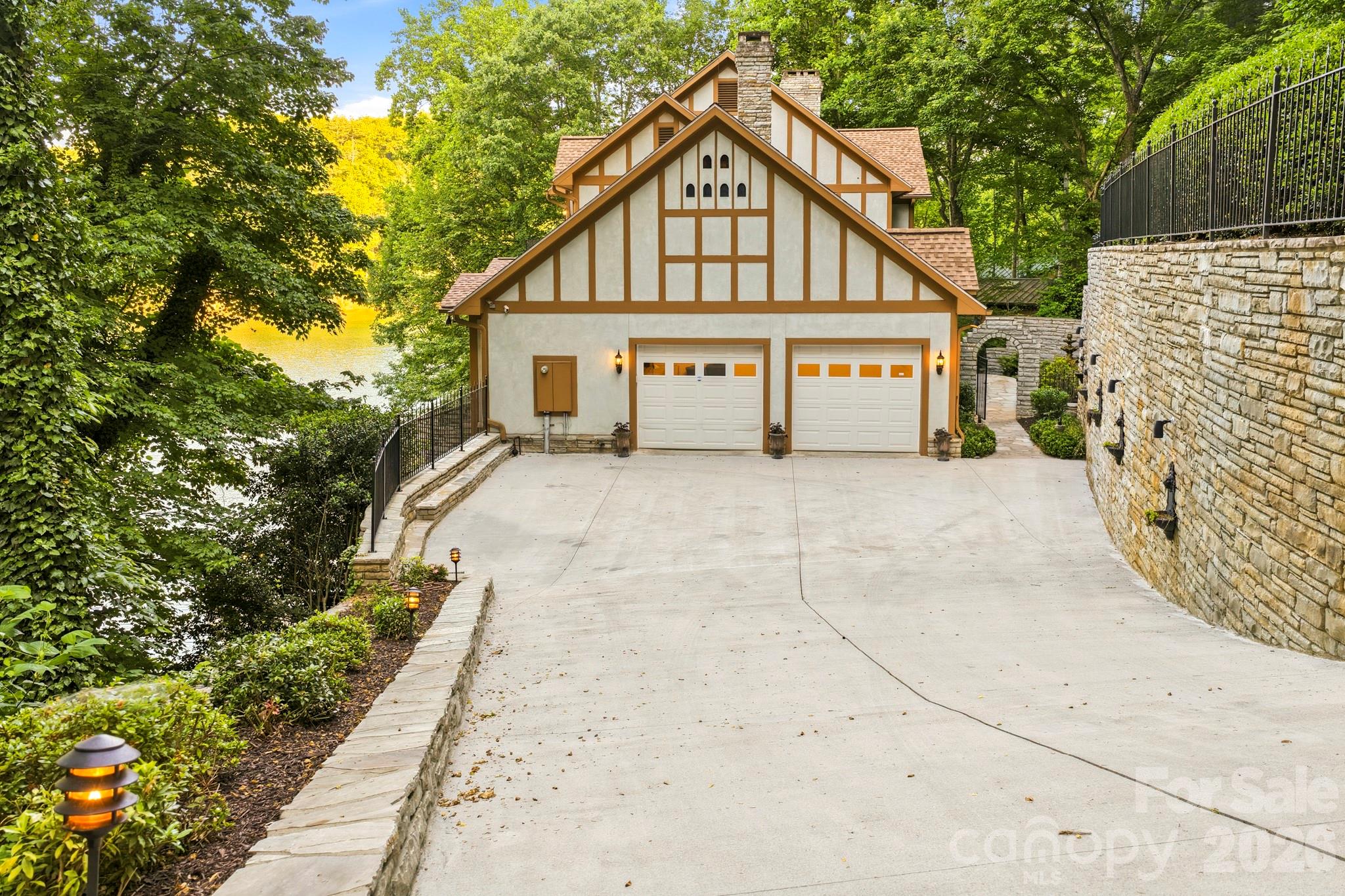 151 Garner Road Lake Lure, NC 28746 - Photo 45 of 48 a view of a big house with wooden fence next to a road