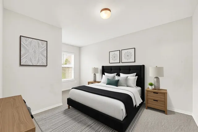 a bedroom with a bed and a night stand