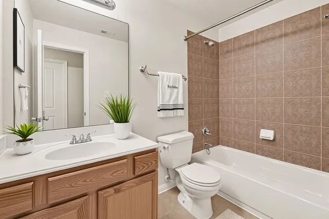 a bathroom with a sink a toilet and tub