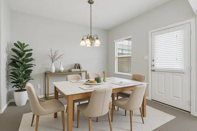 a dining room with furniture potted plants and wooden floor