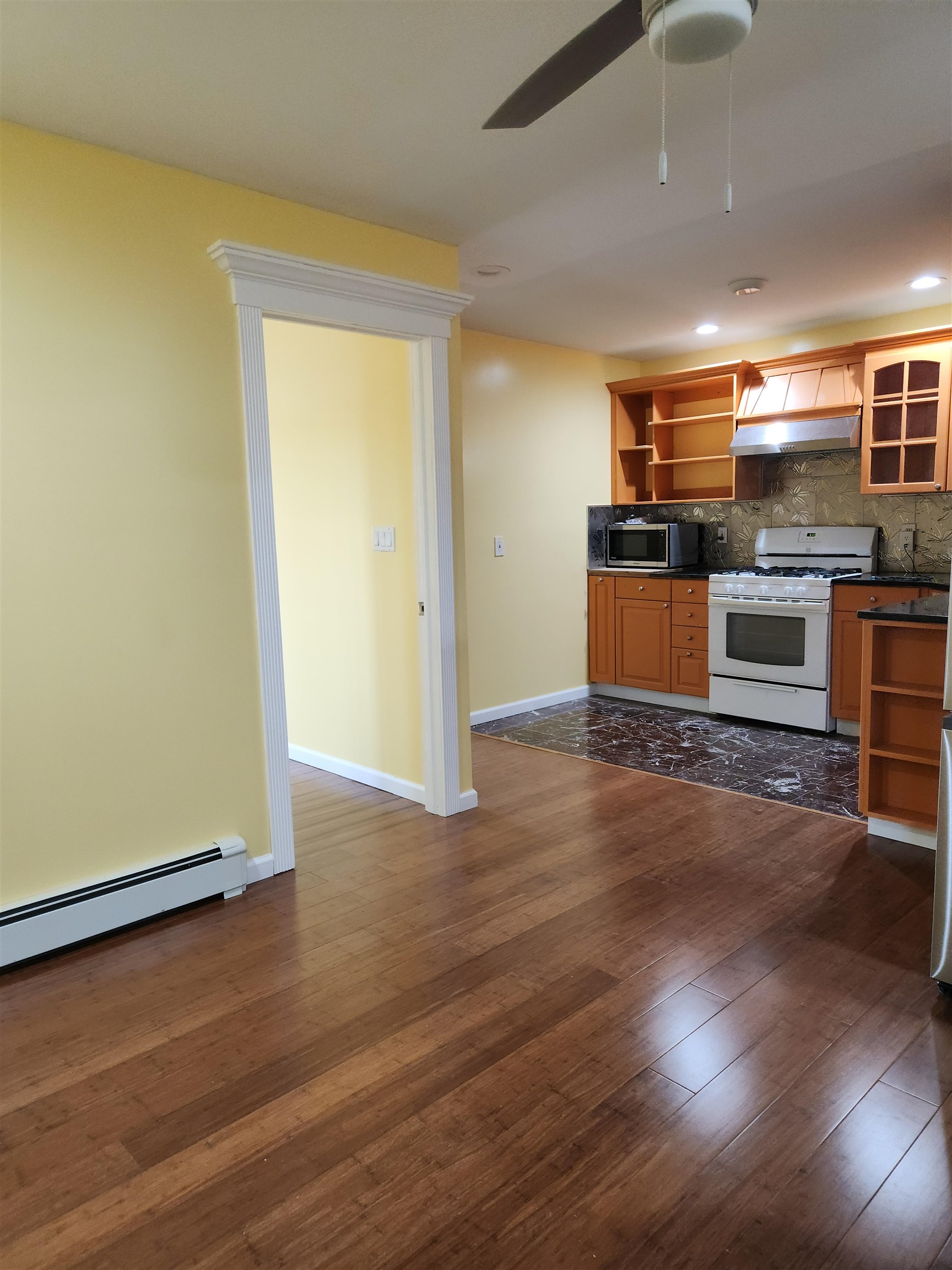39 Terhune Avenue, Unit 2 Jersey City, NJ 07305 - Photo 2 of 10 a kitchen with stainless steel appliances wooden floor and large windows