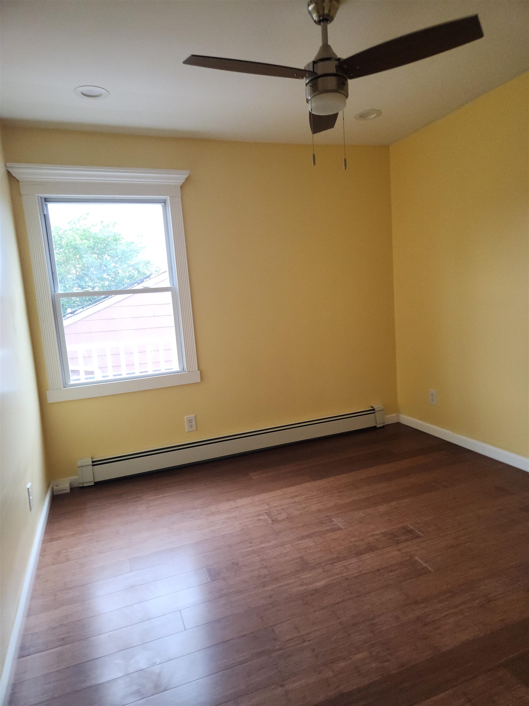 39 Terhune Avenue, Unit 2 Jersey City, NJ 07305 - Photo 7 of 10 a view of a room with wooden floor and a window