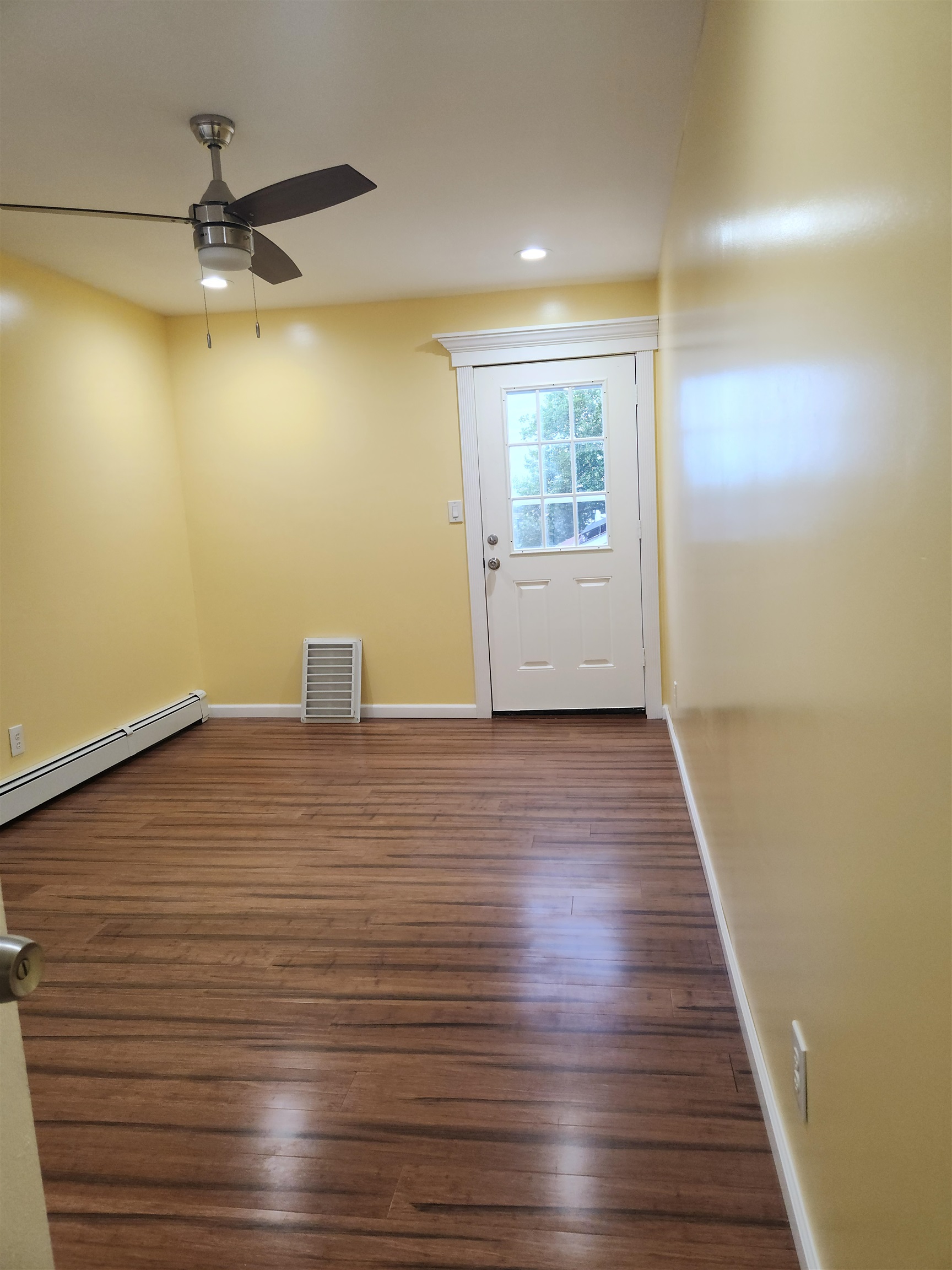 39 Terhune Avenue, Unit 2 Jersey City, NJ 07305 - Photo 8 of 10 an empty room with wooden floor and windows
