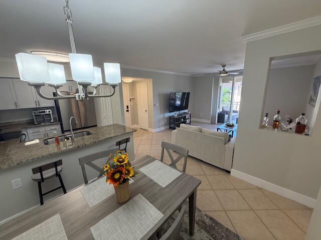 6400 Emerald Dunes Drive, Unit 301 West Palm Beach, FL 33411 - Photo 12 of 28 a living room with furniture and a chandelier