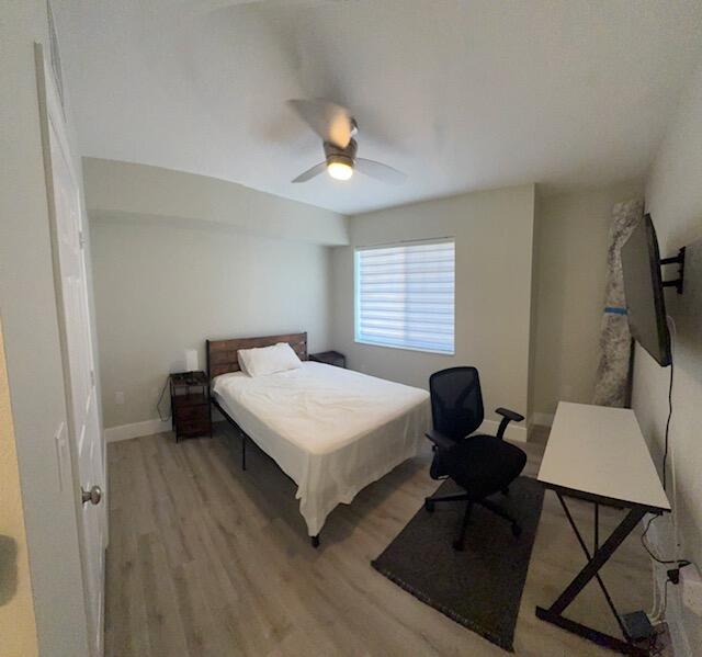 6400 Emerald Dunes Drive, Unit 301 West Palm Beach, FL 33411 - Photo 16 of 28 a bedroom with a bed and a chandelier