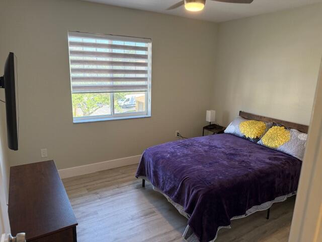 6400 Emerald Dunes Drive, Unit 301 West Palm Beach, FL 33411 - Photo 18 of 28 a bed sitting in a bedroom next to a window