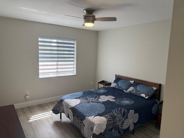 6400 Emerald Dunes Drive, Unit 301 West Palm Beach, FL 33411 - Photo 20 of 28 a bed sitting in a bedroom next to a window
