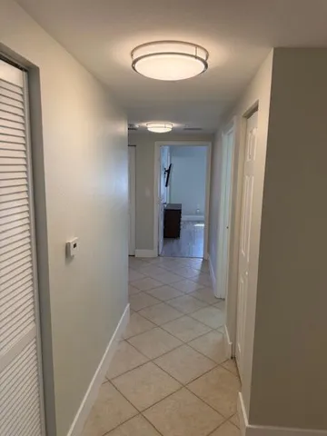 a view of a hallway with wooden shelves