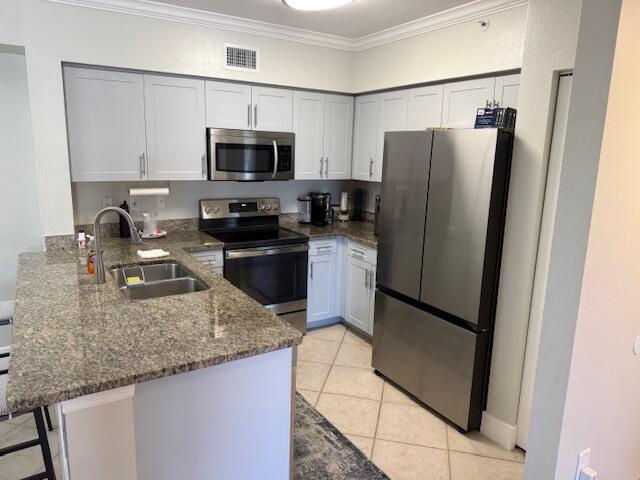 6400 Emerald Dunes Drive, Unit 301 West Palm Beach, FL 33411 - Photo 8 of 28 a kitchen with granite countertop a refrigerator and a sink