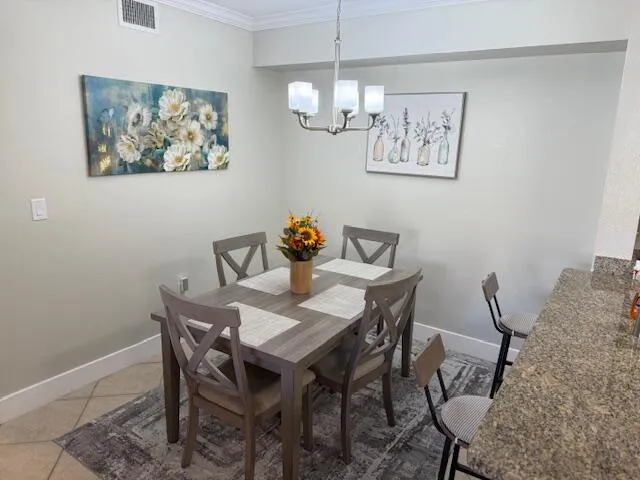 a view of a dining room with furniture and chandelier