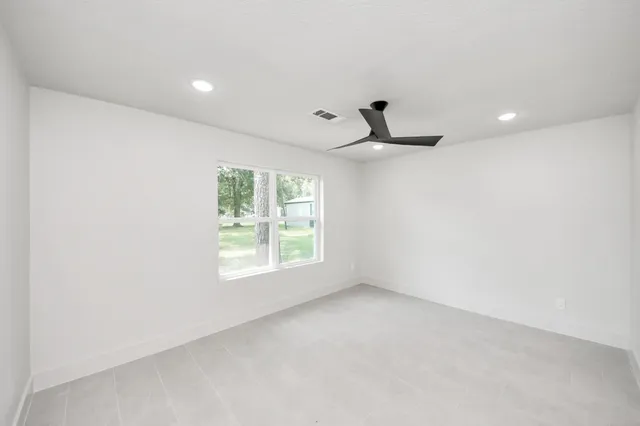 an empty room with windows and closet