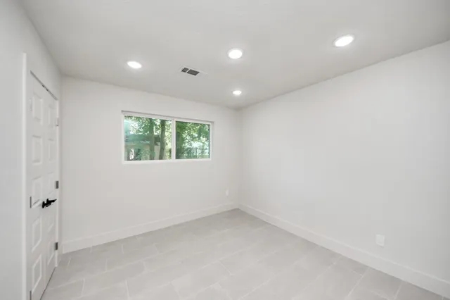 a bathroom with a granite countertop toilet sink and mirror