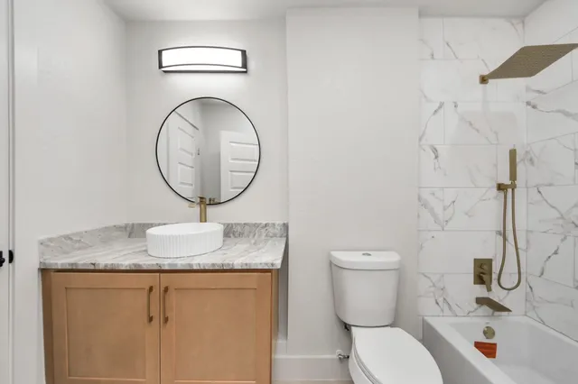 a bathroom with a sink a toilet and a mirror