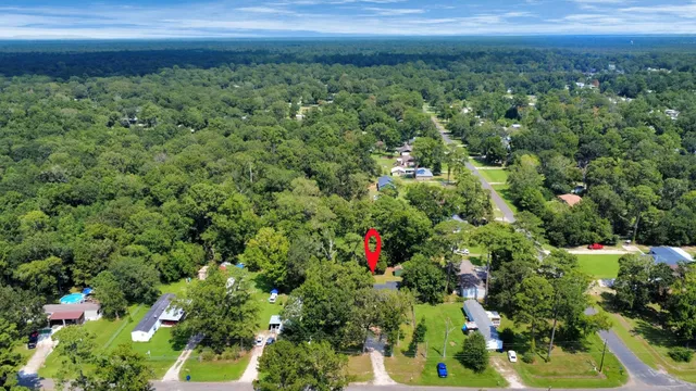an aerial view of a house with a yard