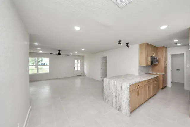 a kitchen with stainless steel appliances granite countertop a large counter top and a stove top oven