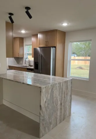 a view of a kitchen with a stove and a large window