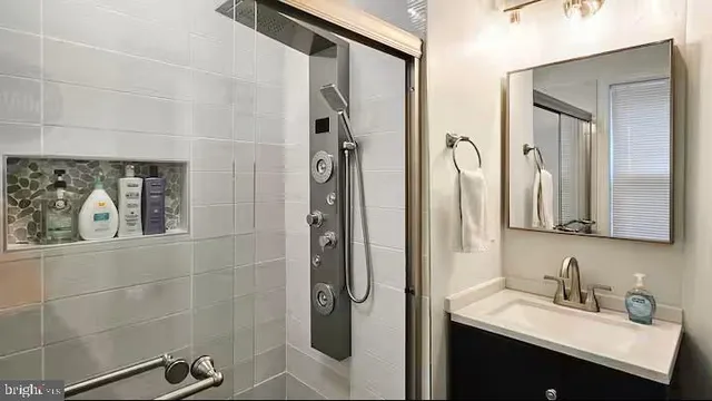 a living room with furniture and a dining table with kitchen view