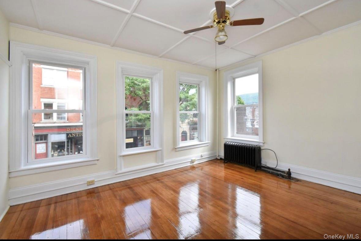 457 Main Street, Unit 1 Beacon, NY 12508 - Photo 5 of 9 a view of an empty room with a window and kitchen area
