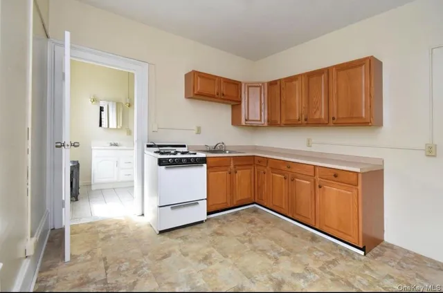 a view of a kitchen with a sink and cabinets