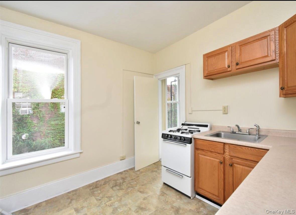 457 Main Street, Unit 1 Beacon, NY 12508 - Photo 9 of 9 a kitchen with stainless steel appliances granite countertop a stove a sink and a microwave