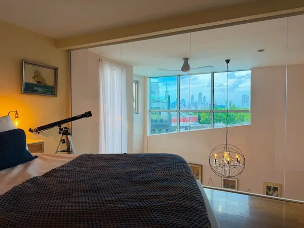 a bedroom with bed and window