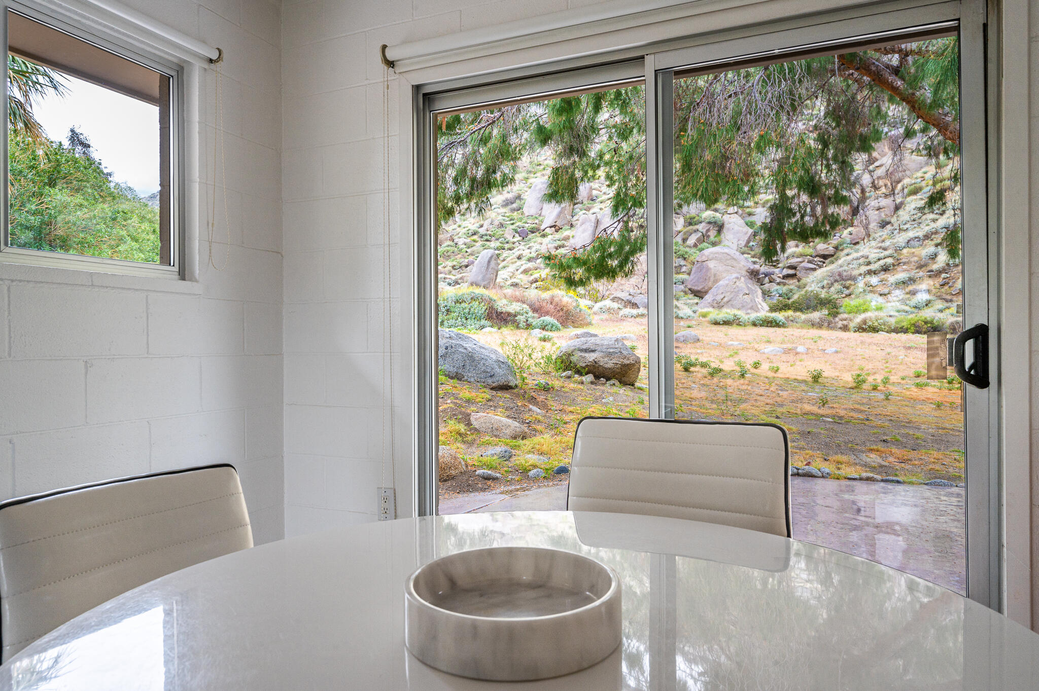 15971 Snowcreek Canyon Road Whitewater, CA 92282 - Photo 13 of 45 a living room with furniture and a floor to ceiling window