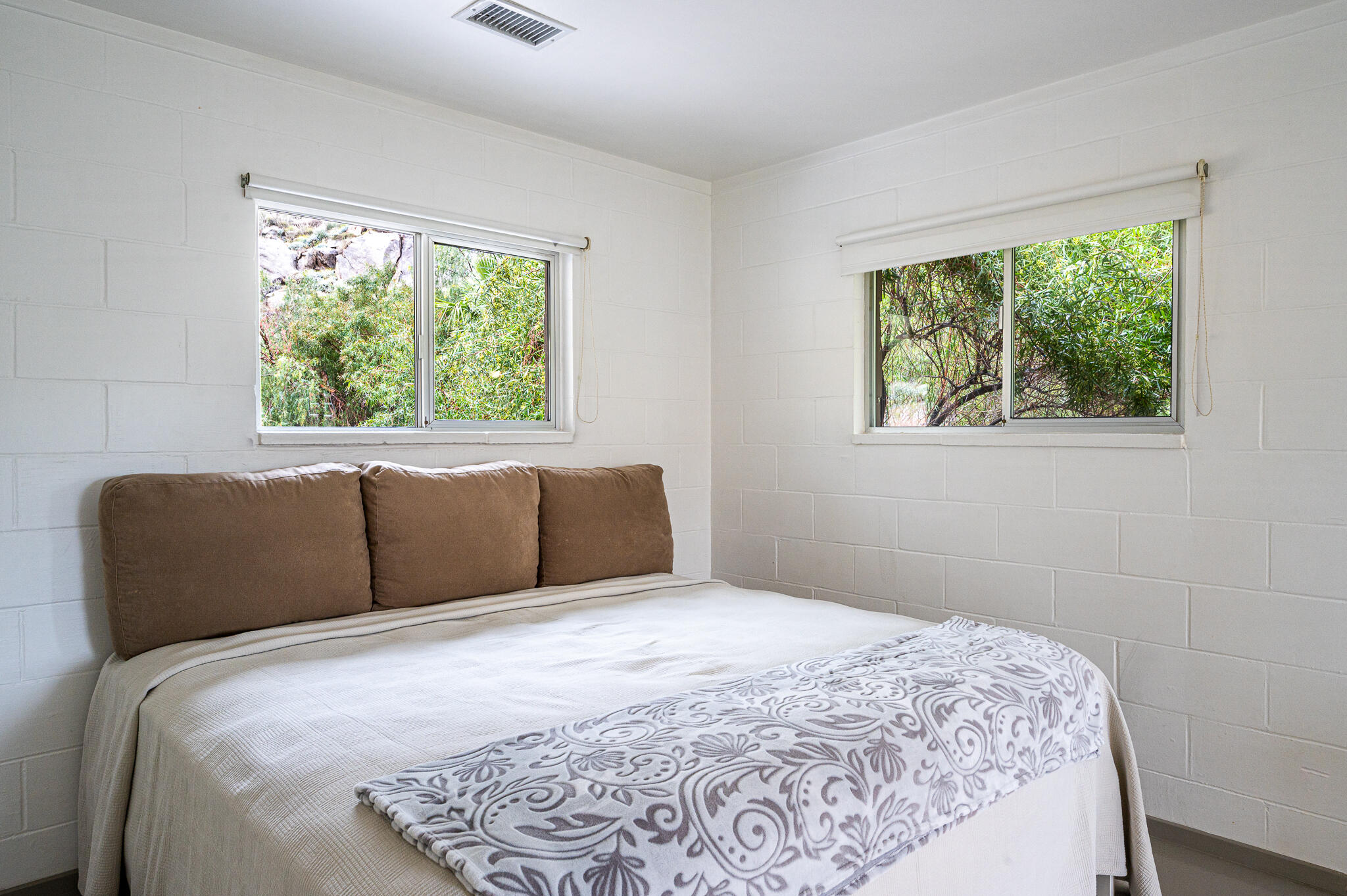 15971 Snowcreek Canyon Road Whitewater, CA 92282 - Photo 14 of 45 a bedroom with a large bed and a window